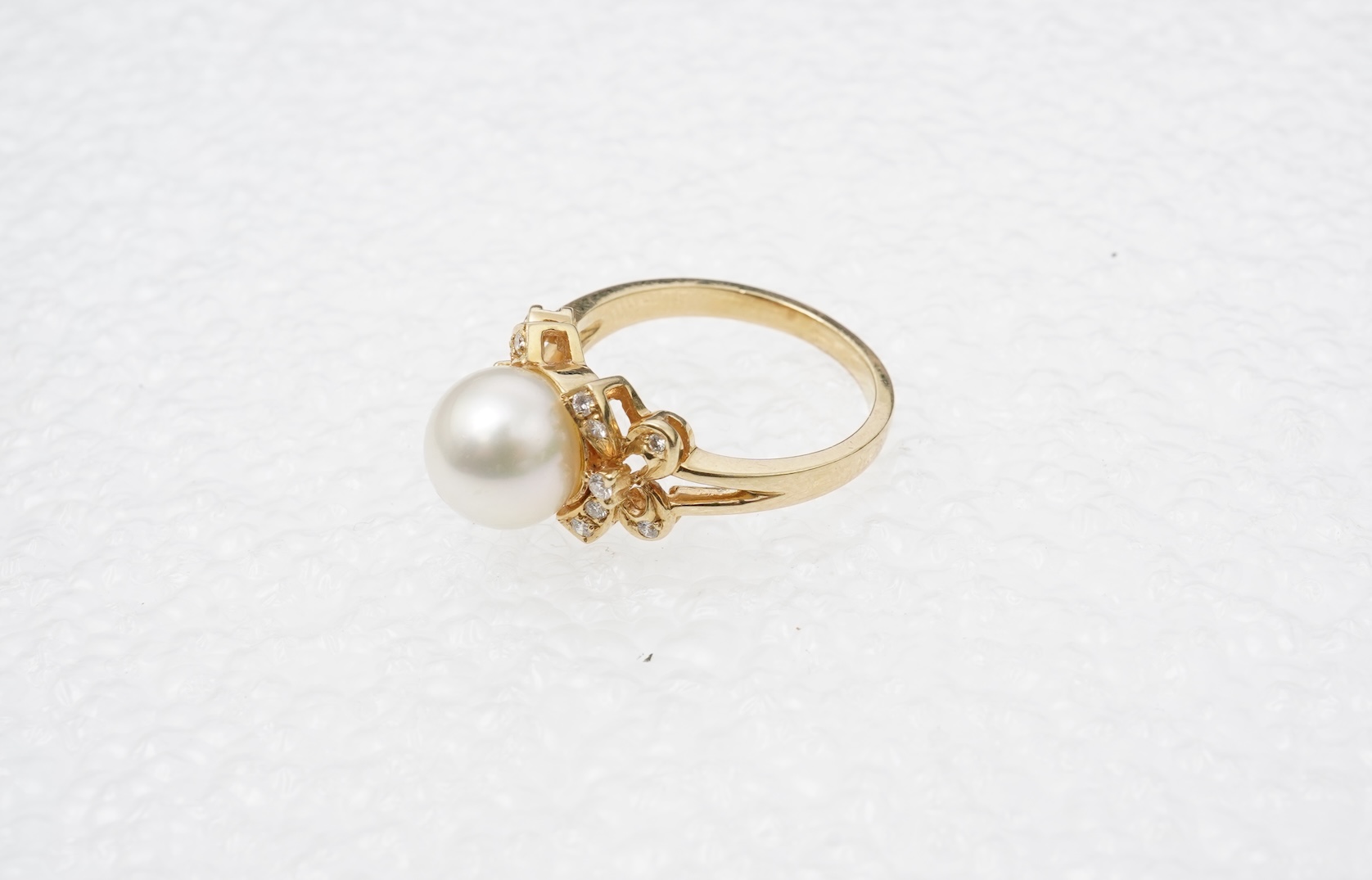 A cultured pearl and diamond ring
